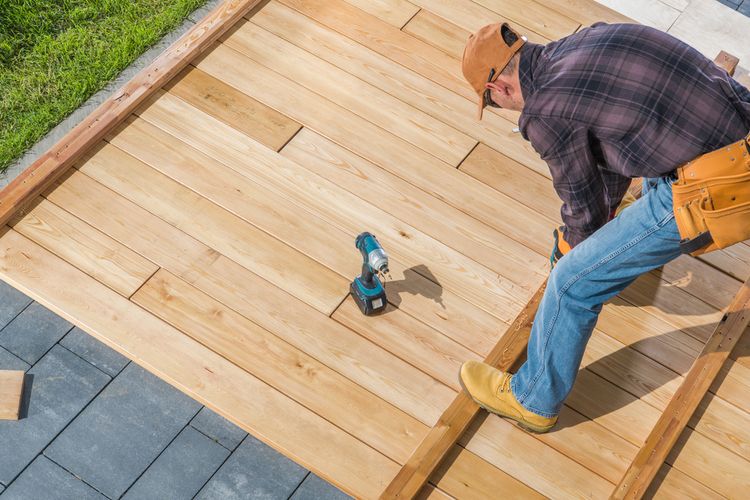 man working to add a deck to a home