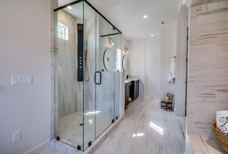 Image is of a luxury shower with a shower window in the stall.