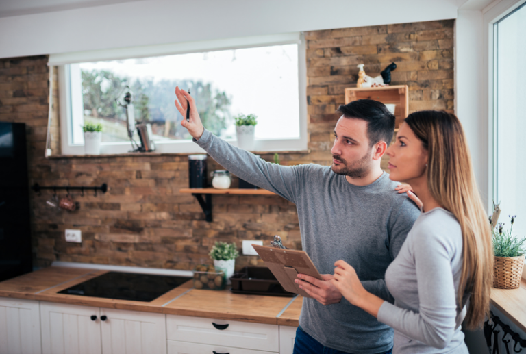 Image is of a couple trying to decide on whether to renovate their house or sell it, concept how new windows can boost your home's appeal