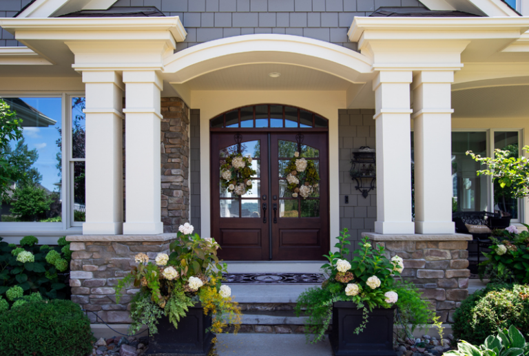 Image is of an exterior vies of a home's front door, concept of summer door maintenance tips