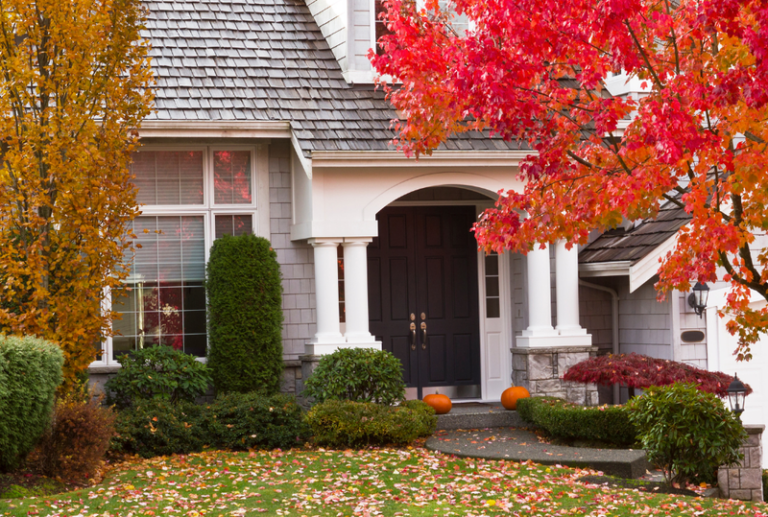 Image is of an exterior view of a home decorated for fall, concept of autumn door checklist.