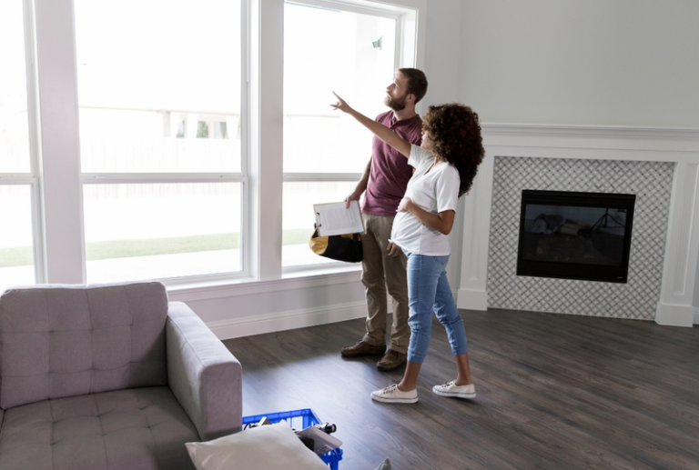 Image is of a pregnant woman talking to her window contractor