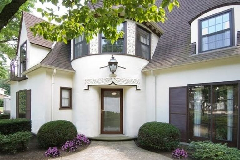 Image is of the exterior of a home looking at the entry door with a glass storm door, concept of the benefits of storm doors