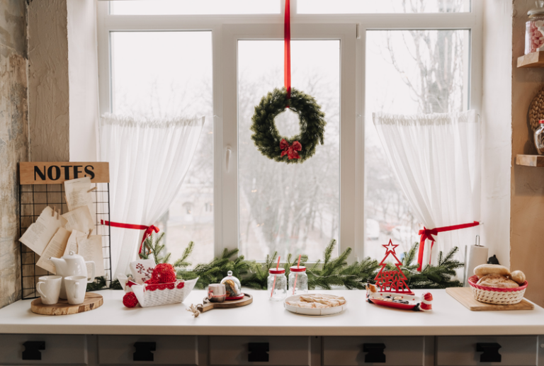 Image is of the interior view of a window with simple Christmas decorations. Concept of easy holiday decorations for the home