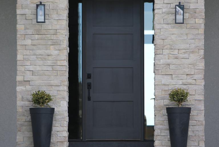 Image is of a modern dark charcoal shaker style four panel door, with full length sidelights, concept of top front door trends 2025